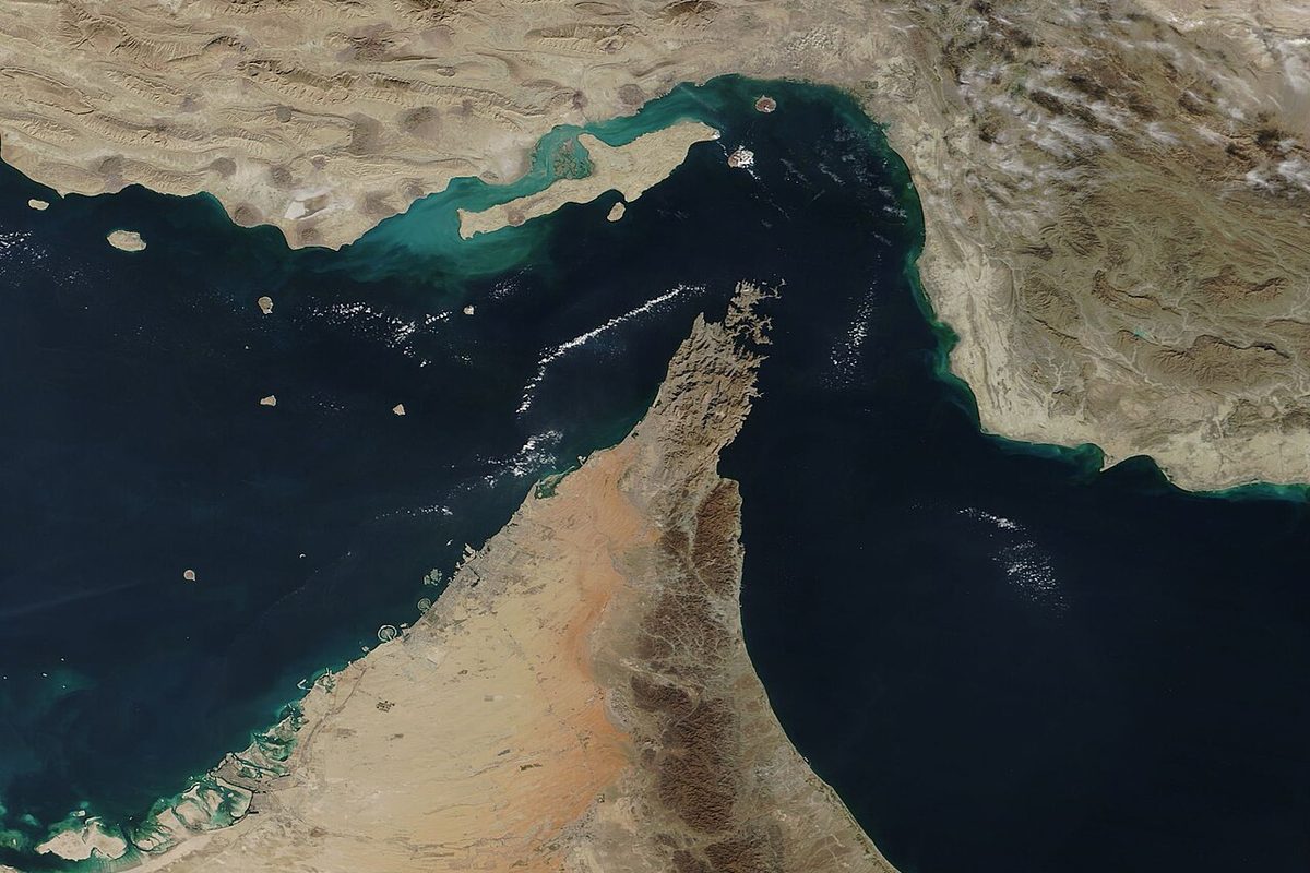Satellite view of the Strait of Hormuz: Iran's coast and Qeshm island to the north, the Musandam peninsula of Oman pointing up from the south